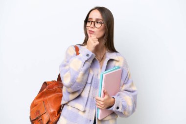 Young beautiful student woman isolated on white background and looking up
