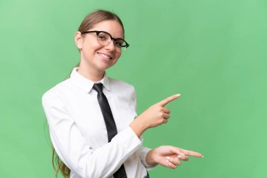 Young business caucasian woman over isolated background pointing finger to the side and presenting a product