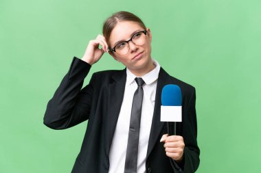 Young TV presenter caucasian woman  over isolated background having doubts and with confuse face expression