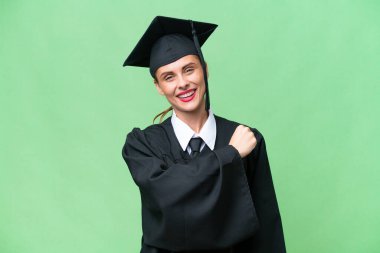Young university graduate  caucasian woman over isolated background celebrating a victory