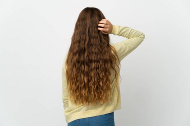 Little girl over isolated white background in back position and thinking