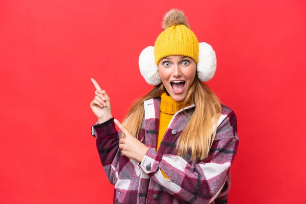 Young Beautiful Woman Wearing Winter Muffs Isolated Red Background Surprised — Stockfoto