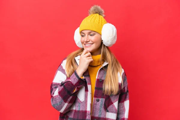 Young Beautiful Woman Wearing Winter Muffs Isolated Red Background Looking — Stockfoto