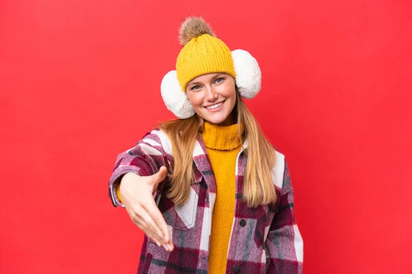 Young Beautiful Woman Wearing Winter Muffs Isolated Red Background Shaking — Stockfoto