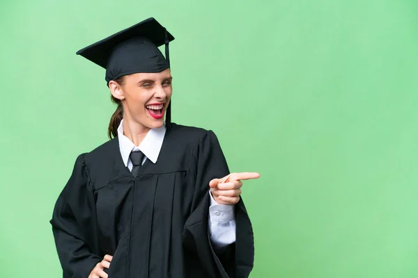 Young university graduate  caucasian woman over isolated background pointing finger to the side and presenting a product