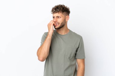 Young caucasian handsome man isolated on white background is a little bit nervous