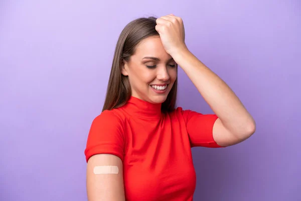 stock image Young caucasian woman wearing band aid isolated on purple background has realized something and intending the solution