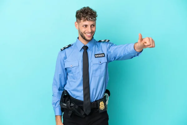 Young police blonde man isolated white on blue background giving a thumbs up gesture