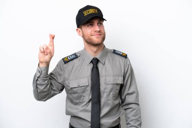 Young safeguard caucasian man isolated on white background with fingers crossing and wishing the best