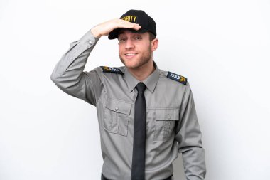 Young safeguard caucasian man isolated on white background looking far away with hand to look something