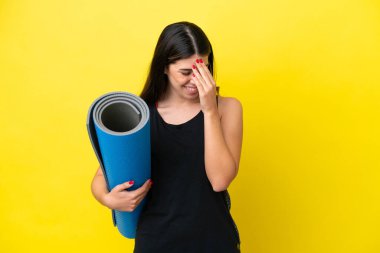 sport Italian woman going to yoga classes isolated on yellow background laughing