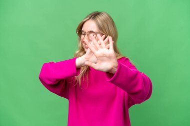 Young English woman over isolated background nervous stretching hands to the front