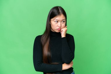 Young Asian woman over isolated chroma key background with tired and bored expression