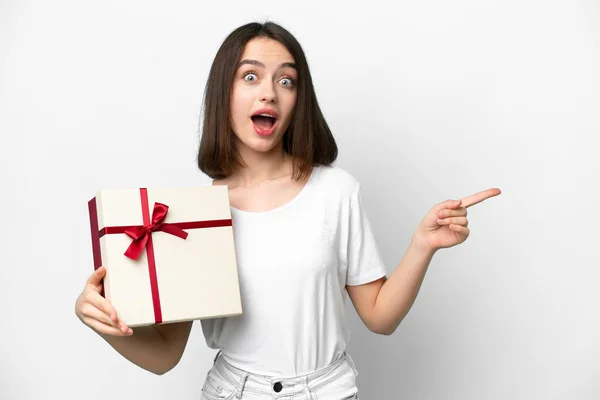 Young Ukrainian Woman Holding Gift Isolated White Background Surprised Pointing — 스톡 사진