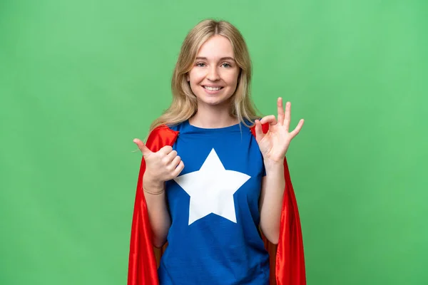Super Hero English woman over isolated background showing ok sign and thumb up gesture