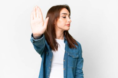 Young caucasian woman over isolated white background making stop gesture and disappointed