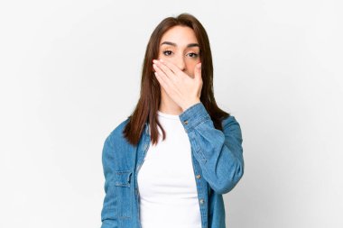 Young caucasian woman over isolated white background covering mouth with hand