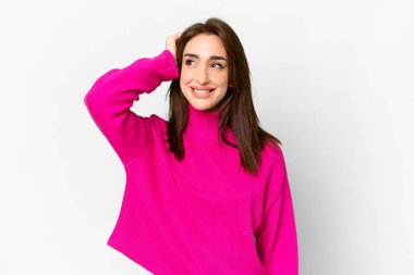 Young caucasian woman over isolated white background having doubts and with confuse face expression