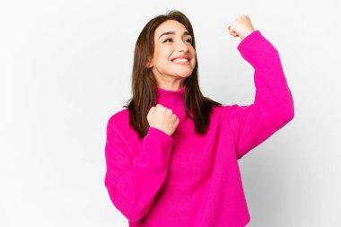 İzole edilmiş beyaz arka planda genç beyaz kadın zaferi kutluyor.