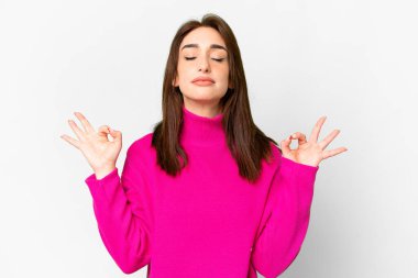 Young caucasian woman over isolated white background in zen pose
