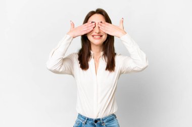 Young caucasian woman over isolated white background covering eyes by hands