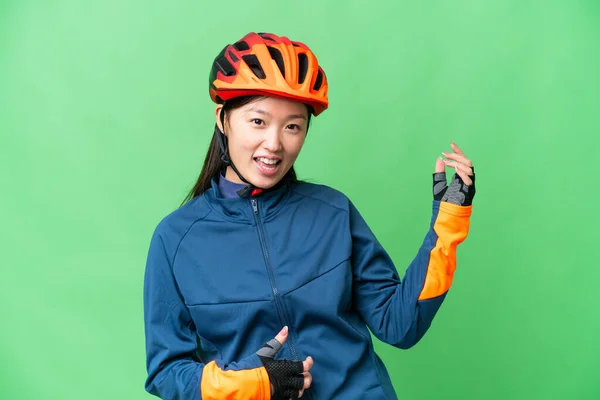 Young Cyclist Woman Isolated Chroma Key Background Making Guitar Gesture — Stockfoto