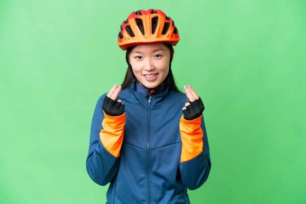 Young Cyclist Woman Isolated Chroma Key Background Making Money Gesture — Stockfoto