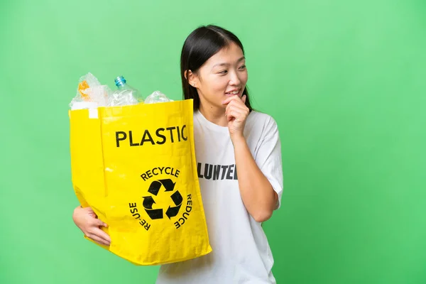 Young Asian Woman Holding Bag Full Plastic Bottles Recycle Isolated — стокове фото