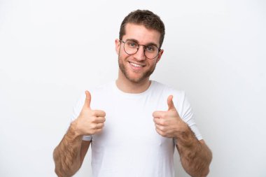 Young caucasian man isolated on white background With glasses and with thumb up