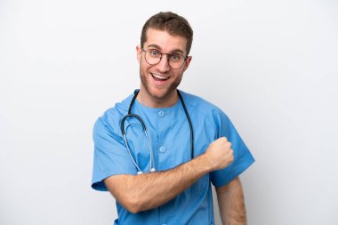 Young surgeon doctor caucasian man isolated on white background celebrating a victory