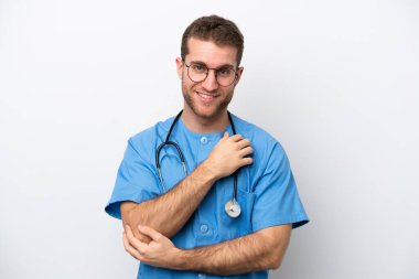 Young surgeon doctor caucasian man isolated on white background with glasses and smiling