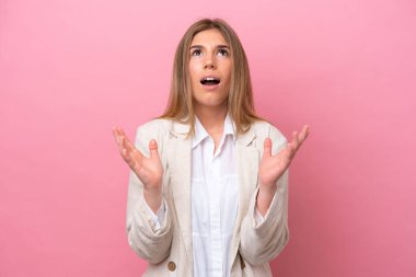 Young caucasian woman isolated on pink bakcground stressed overwhelmed