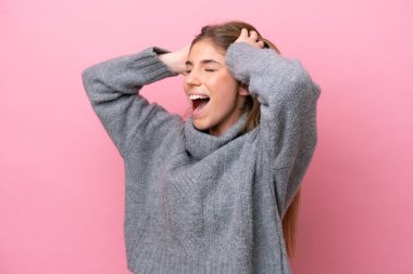 Young caucasian woman isolated on pink bakcground stressed overwhelmed