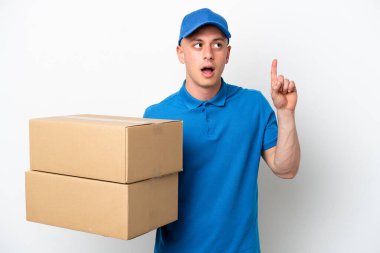 Young delivery Brazilian man isolated ops white background thinking an idea pointing the finger up