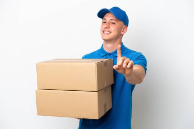 Young delivery Brazilian man isolated ops white background showing and lifting a finger