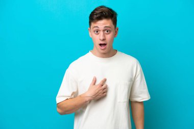 Young handsome Brazilian man isolated on blue background pointing to oneself
