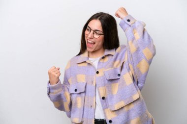 Young girl isolated on white background celebrating a victory