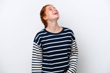 Kırmızımsı genç kadın beyaz arka planda yalnız gülüyor.