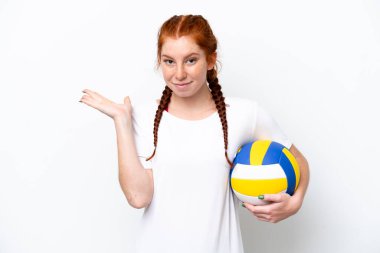 Young caucasian reddish woman playing volleyball isolated on white background having doubts while raising hands