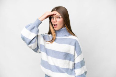 Teenager girl over isolated white background doing surprise gesture while looking front