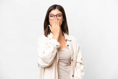 Young Russian woman over isolated white background covering mouth with hand