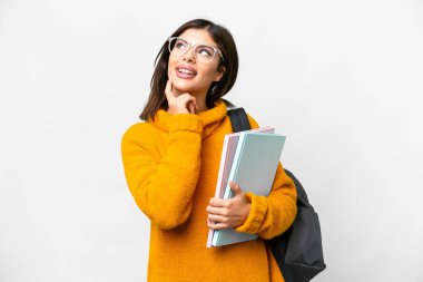 Young student woman over isolated white background thinking an idea while looking up