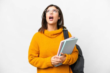 Young student woman over isolated white background looking up and with surprised expression