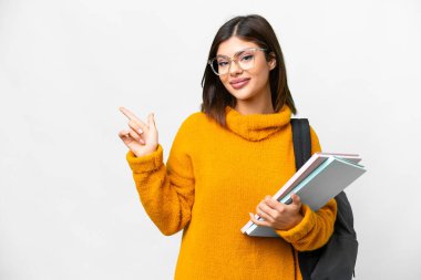 Young student woman over isolated white background pointing finger to the side