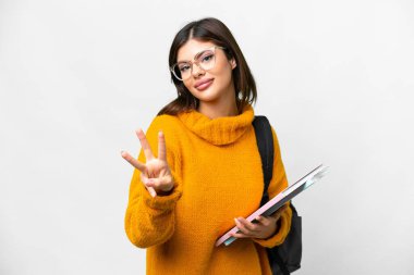 Young student woman over isolated white background happy and counting three with fingers