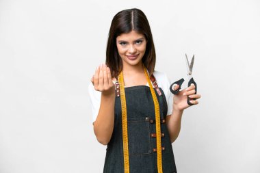 Seamstress woman over isolated white background inviting to come with hand. Happy that you came