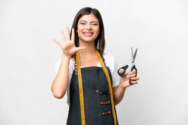 Seamstress woman over isolated white background counting five with fingers