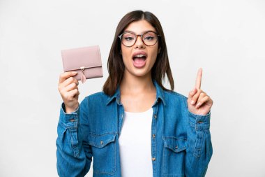 Young Russian woman holding a wallet over isolated white background pointing up a great idea