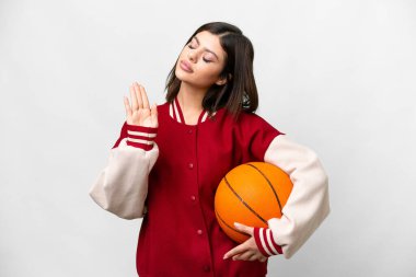 Young Russian woman playing basketball over isolated white background making stop gesture and disappointed