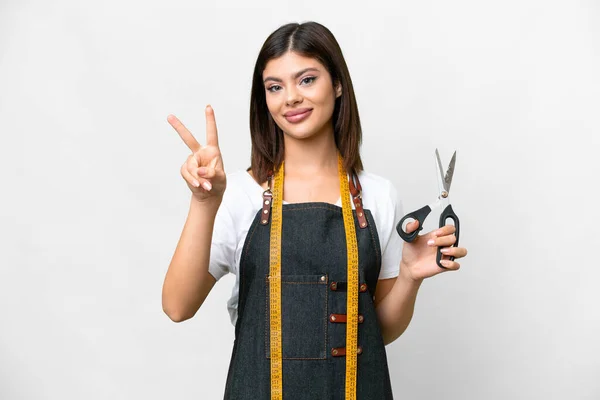 Seamstress Woman Isolated White Background Smiling Showing Victory Sign — Stockfoto